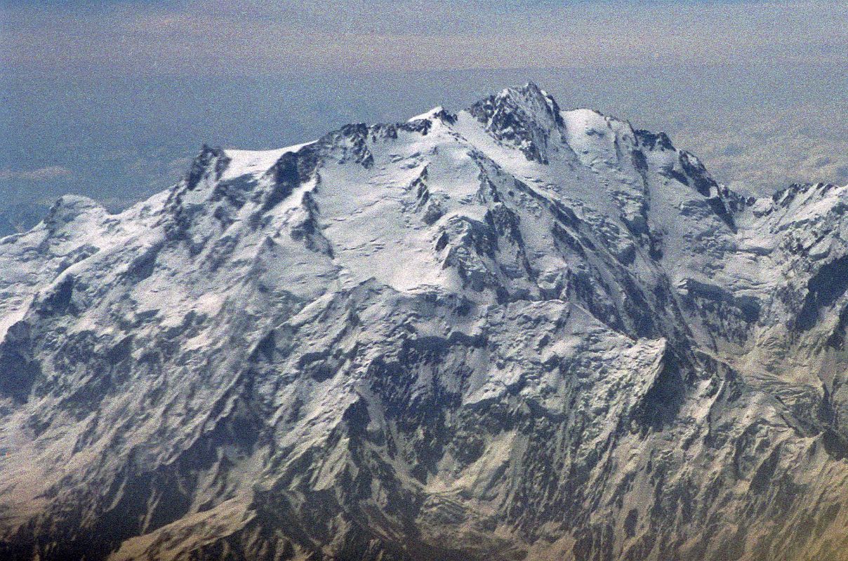 08 Nanga Parbat Diamir Face And Summit Close Up On Flight From Islamabad To Skardu The plane continues flying around Nanga Parbat with Rakhiot Peak, the East Peak, the Silver Plateau, the North Peaks, the summit above the Diamir Face and the beginning of the Mazeno Ridge on the far right.